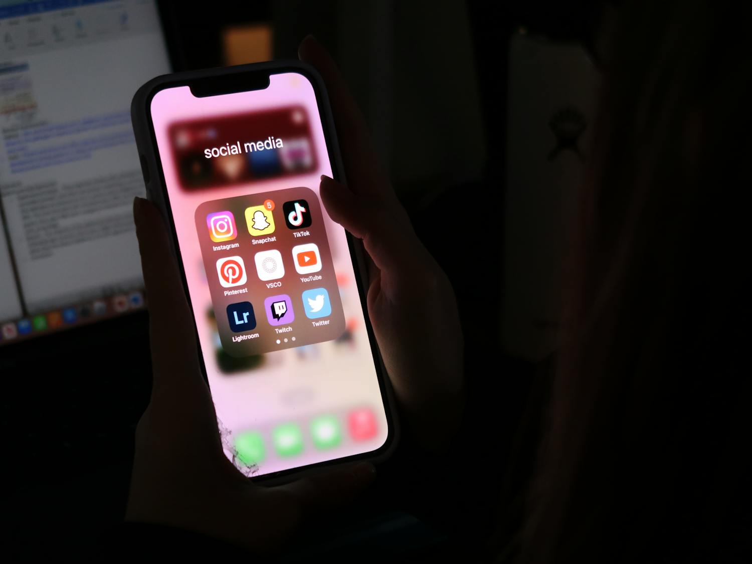 A photo illustration of student opening the popular social media app, TikTok, in her dorm on Feb. 5, 2023. Despite a bill circling the Statehouse that will ban TikTok on government devices, USC said the bill will not affect student's access to it on campus.