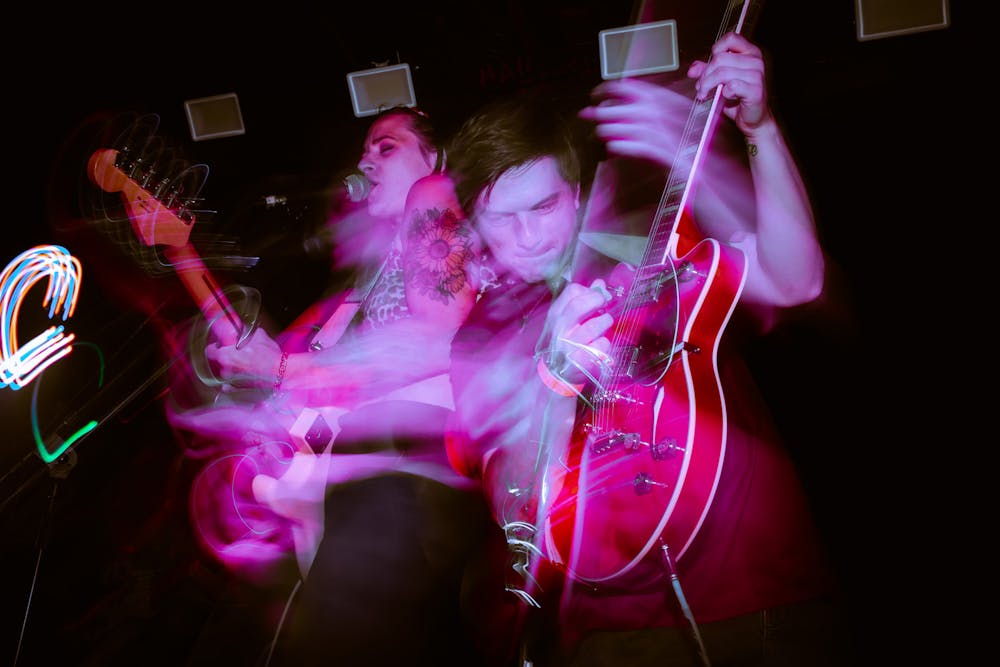 <p>A long exposure shot of Charlie Boy band members, frontwoman Kat Hammond and guitarist Tyler Gordon, performing on July 1, 2022. The group has performed at New Brooklyn Tavern but is looking to expand its unique sound beyond Columbia.</p>