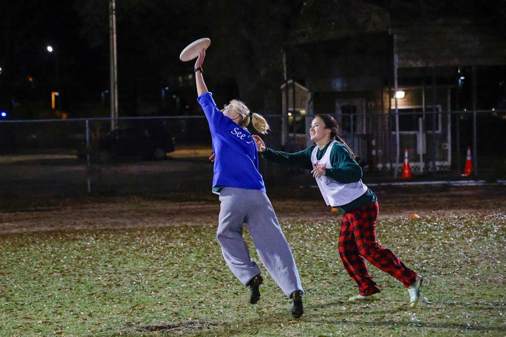 <p>A USC Women's Ultimate Frisbee Club team player jumps to catch a disc during practice at Bluff Fields on Jan. 28, 2025. The team practices every Tuesday and Thursday from 9 p.m to 11 p.m.</p>