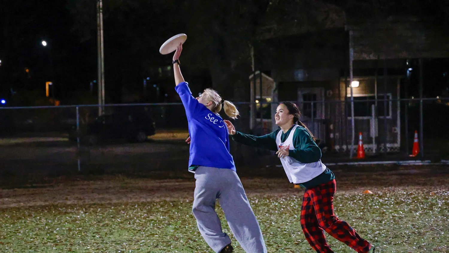 A USC Women's Ultimate Frisbee Club team player jumps to catch a disc during practice at Bluff Fields on Jan. 28, 2025. The team practices every Tuesday and Thursday from 9 p.m to 11 p.m.