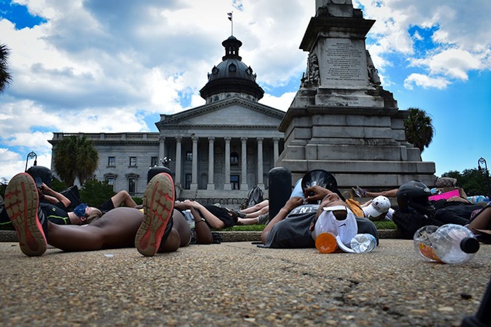 <p>Peaceful protesters lie down in front of the Statehouse Monday for a "Die-In."</p>