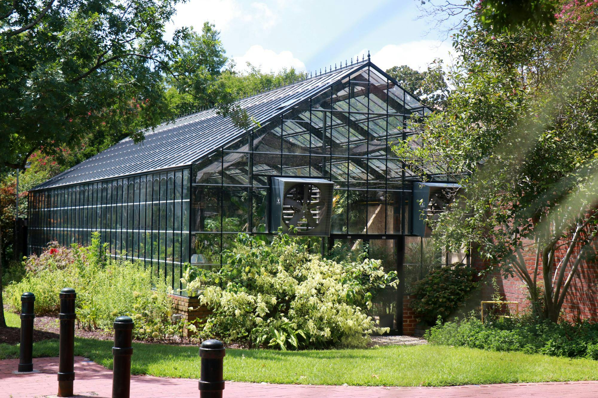 The University Greenhouse sits behind the University President's House on Aug. 20, 2024. The greenhouse houses a variety of plants and is mainly used to grow potted plants for events around campus.