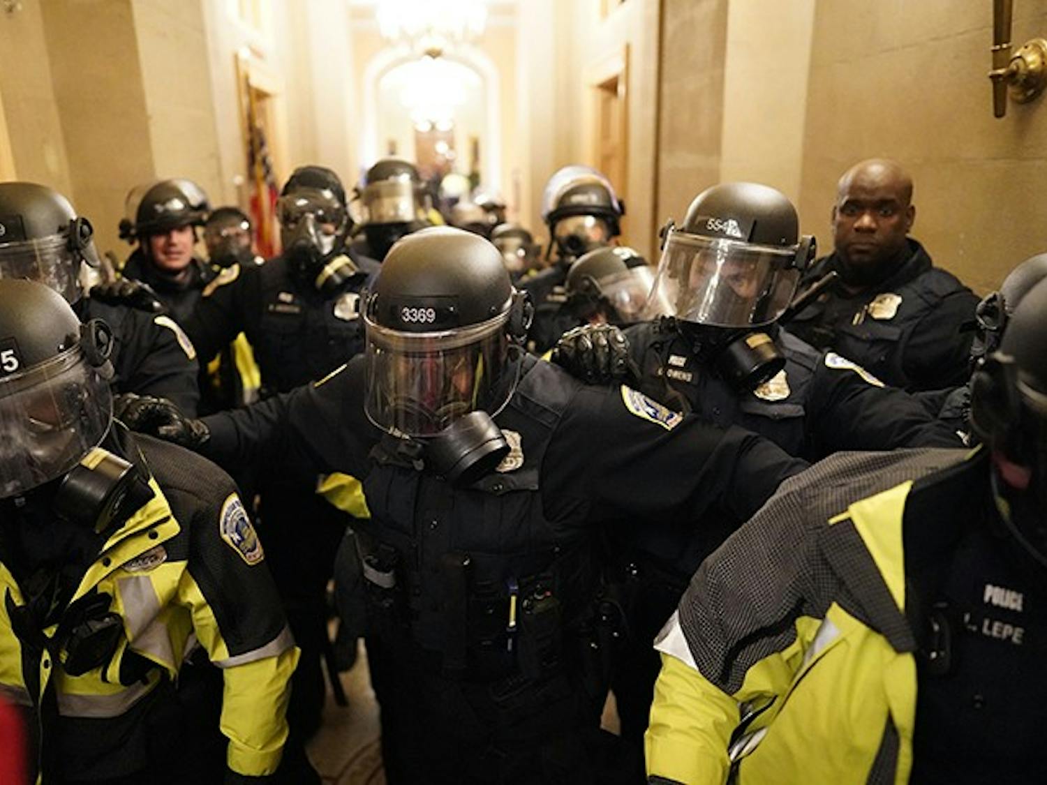 Riot police clear the hallway inside the Capitol on Wednesday, Jan. 6, 2021, in Washington, D.C. 