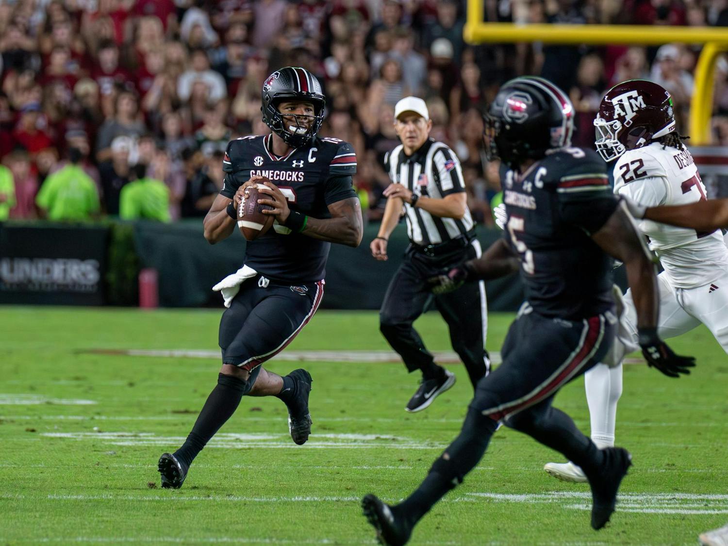 Redshirt freshman quarterback LaNorris Sellers looks for a receiver downfield while being chased by a Texas A&M defender on Nov. 2, 2024, at Williams-Brice Stadium. Sellers threw for 244 yards, completing 2 touchdowns and earning a 48% completion percentage against the No. 10 Aggies.