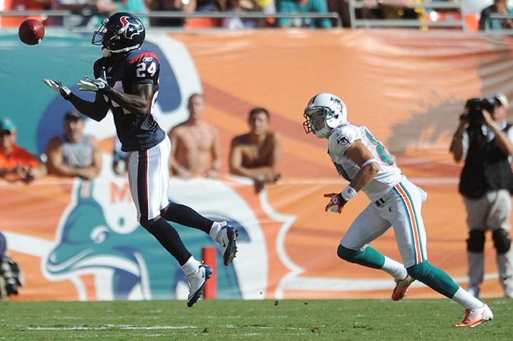 Jonathan Joseph of the Texans intercepts a pass intended for Brian Hartline of the Dolphins. The Houston Texans defeated the Miami Dolphins, 23-13, at Sun Life Stadium in Miami Gardens, Florida, Sunday, September 18, 2011. (Jim Rassol/Sun Sentinel/MCT)