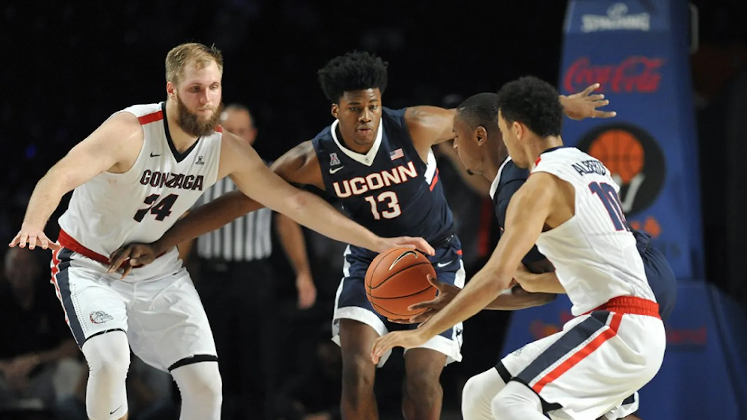 Gonzaga Bulldogs center Przemek Karnowski (24), left, and Connecticut Huskies forward Steven Enoch (13) look on as Connecticut Huskies guard Sterling Gibbs (4) scoops up a loose ball in front of Gonzaga Bulldogs guard Bryan Alberts (10) during the third/fourth place game of the Battle 4 Atlantis on Friday, Nov. 27, 2015, in Nassau, Bahamas. (Brad Horrigan/Hartford Courant/TNS)