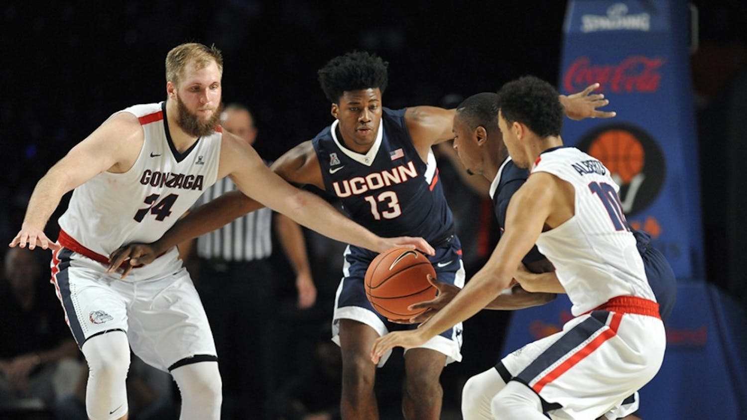 Gonzaga Bulldogs center Przemek Karnowski (24), left, and Connecticut Huskies forward Steven Enoch (13) look on as Connecticut Huskies guard Sterling Gibbs (4) scoops up a loose ball in front of Gonzaga Bulldogs guard Bryan Alberts (10) during the third/fourth place game of the Battle 4 Atlantis on Friday, Nov. 27, 2015, in Nassau, Bahamas. (Brad Horrigan/Hartford Courant/TNS)