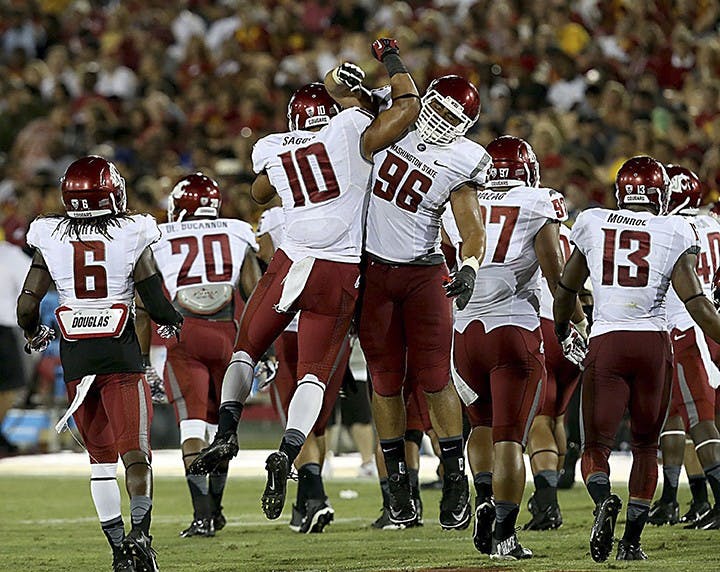 Washington State defenders Justin Sagote (10) and Xavier Cooper (96) celebrate after blocking a field goal attempt by USC&apos;s Andrew Furney in the third quarter at the Los Angeles Coliseum on Saturday, September 7, 2013, in Los Angeles, California. (Luis Sinco/Los Angeles Times/MCT)
