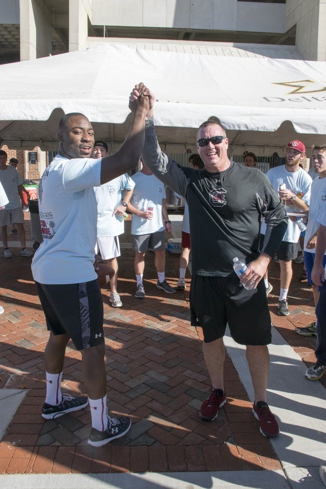 Former star running back Marcus Lattimore and Interim Head Coach Shawn Elliot came together to support Lattimore's foundation as a part of this year's annual Game Ball Run.