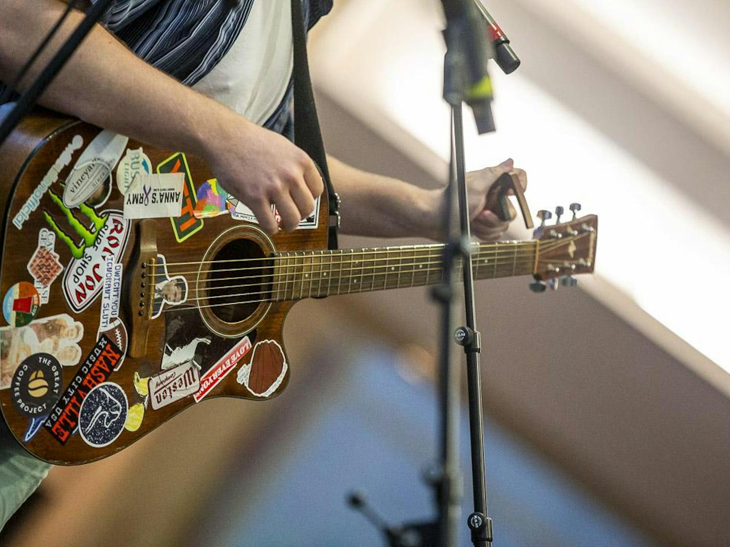 Will Cullen puts a capo on his guitar during his headlining performance at the Koger Center on Aug. 27, 2023. Cullen, a Whitewater, Mich., native performed a mix of country and pop mashups and some of his hit songs.