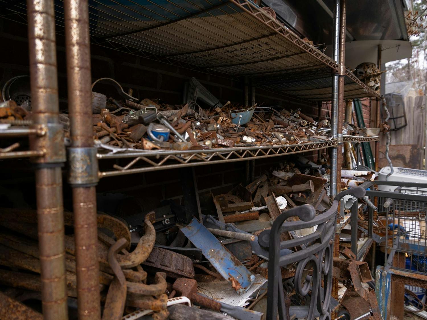 Shelves at Humphries' workshop in West Columbia are lined with discarded items that he repurposes to help form his art. When creating sculptures, Humphries moves piles of supplies to the floor where he is building and only goes back to the shelves when he runs out of material on the floor.