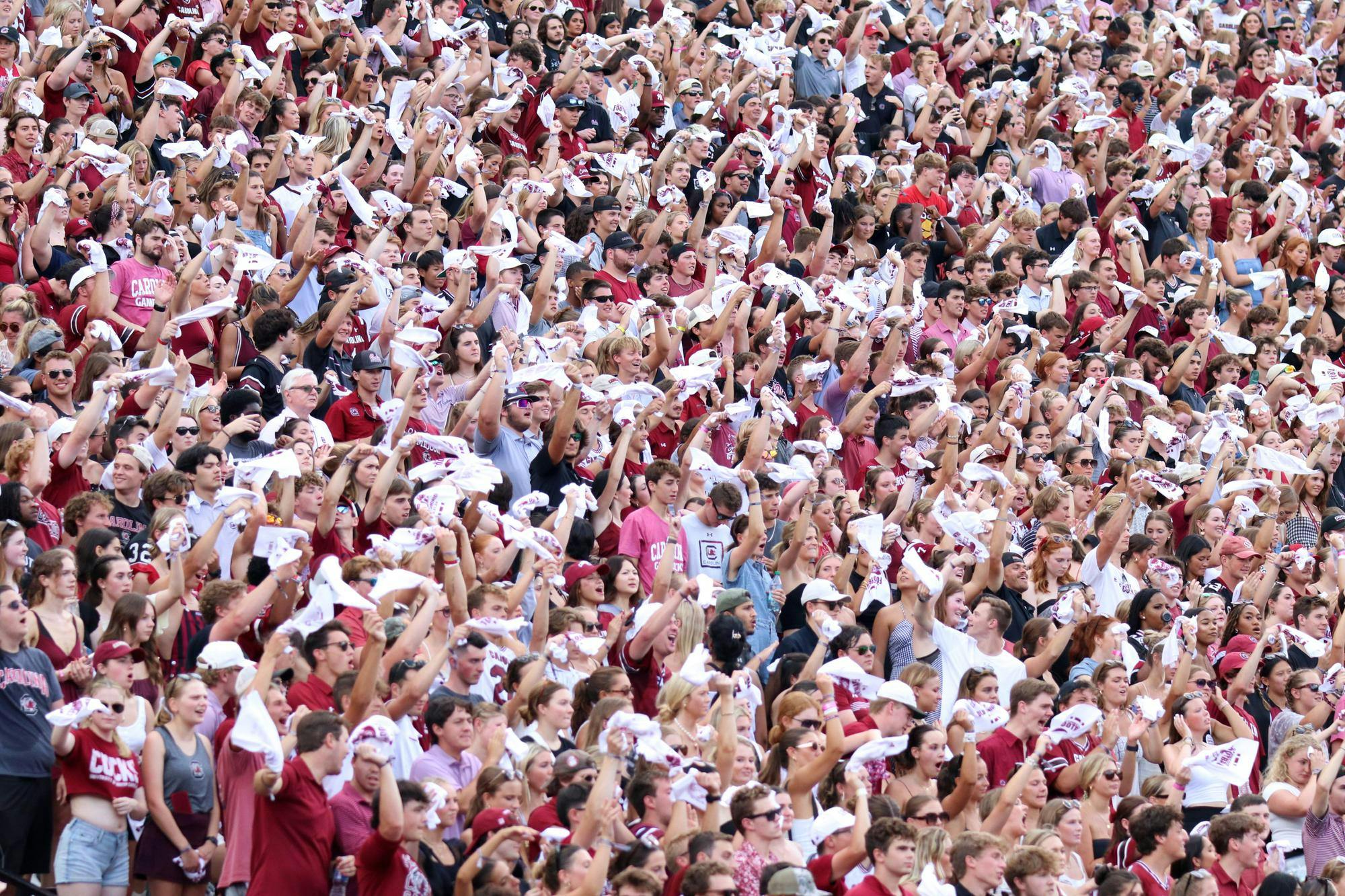 FILE — University of South Carolina students sitting in the student section wave their rally towels at the start of a football game on Aug. 31, 2024. The 2024 season marks 15 years where South Carolina has had its Sandstorm tradition at games.