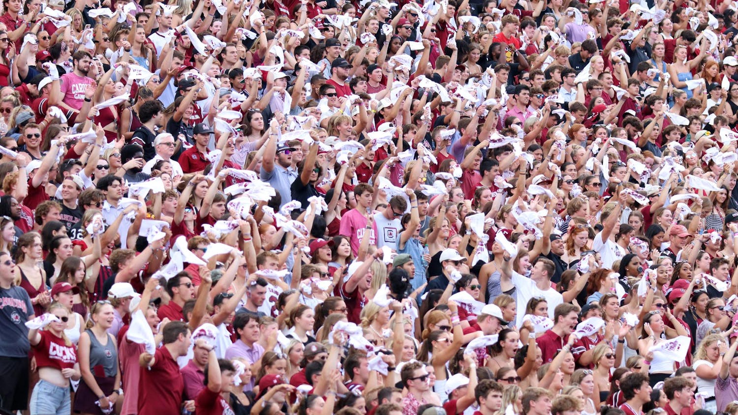 FILE — University of South Carolina students sitting in the student section wave their rally towels at the start of a football game on Aug. 31, 2024. The 2024 season marks 15 years where South Carolina has had its Sandstorm tradition at games.