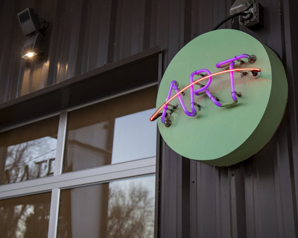 <p>A neon sign hangs outside one of the workshops of the Stormwater Studios building on Pendleton Street on Feb. 19, 2023. The art studio will be hosting award-winning photographer, filmmaker and documentarian Gerry Melendez's exhibition titled "Whole" from Feb. 21 to March 5, 2023.&nbsp;</p>