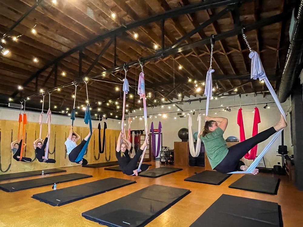 Group participates in aerial yoga at Fit Columbia on College St. Fit Columbia is an award-winning studio that offers fitness training and yoga
