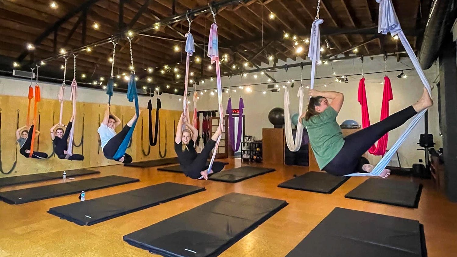 Group participates in aerial yoga at Fit Columbia on College St. Fit Columbia is an award-winning studio that offers fitness training and yoga