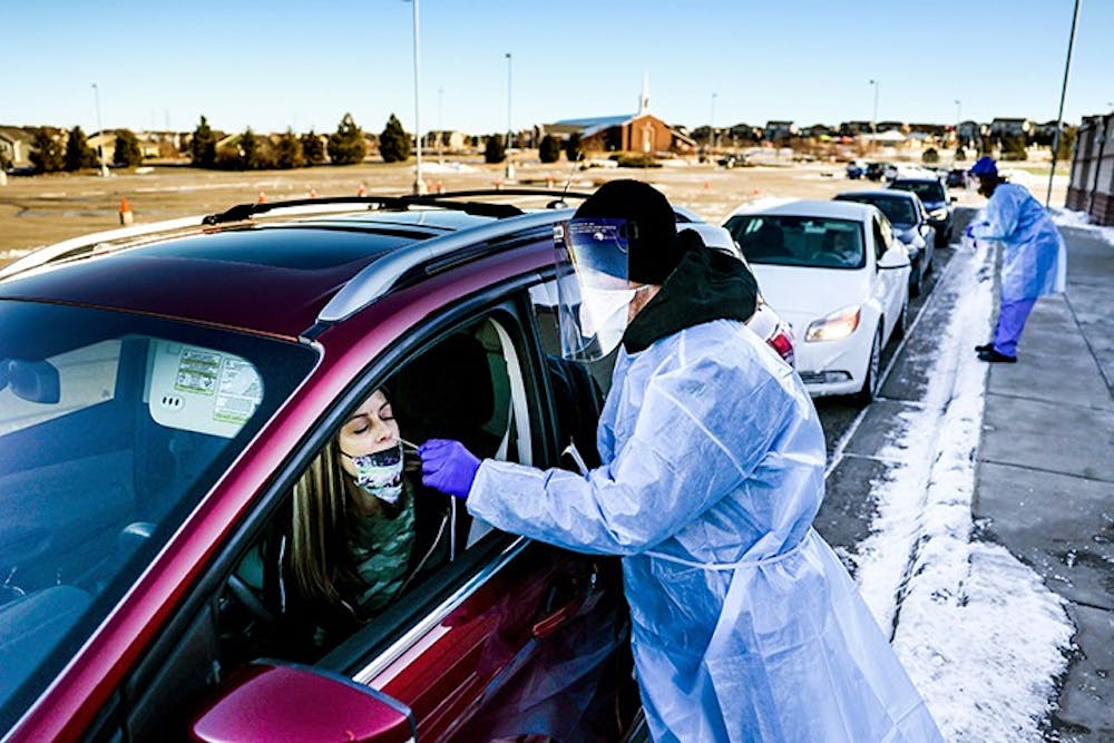 Site tester Bradford Christopher administers a COVID-19 test in Parker, Colorado, the closest testing site to Ebert County where the first positive test for a new highly contagious variant was detected.