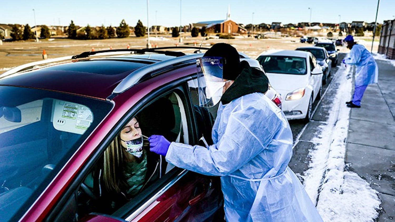 Site tester Bradford Christopher administers a COVID-19 test in Parker, Colorado, the closest testing site to Ebert County where the first positive test for a new highly contagious variant was detected.