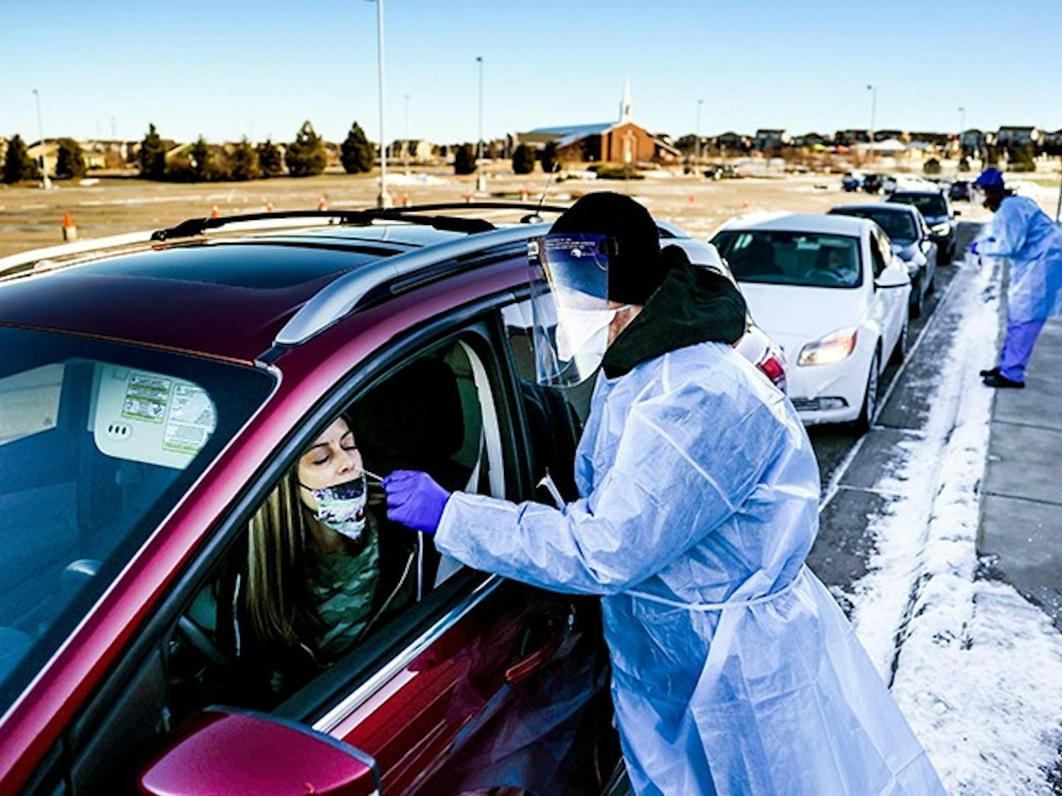 Site tester Bradford Christopher administers a COVID-19 test in Parker, Colorado, the closest testing site to Ebert County where the first positive test for a new highly contagious variant was detected.