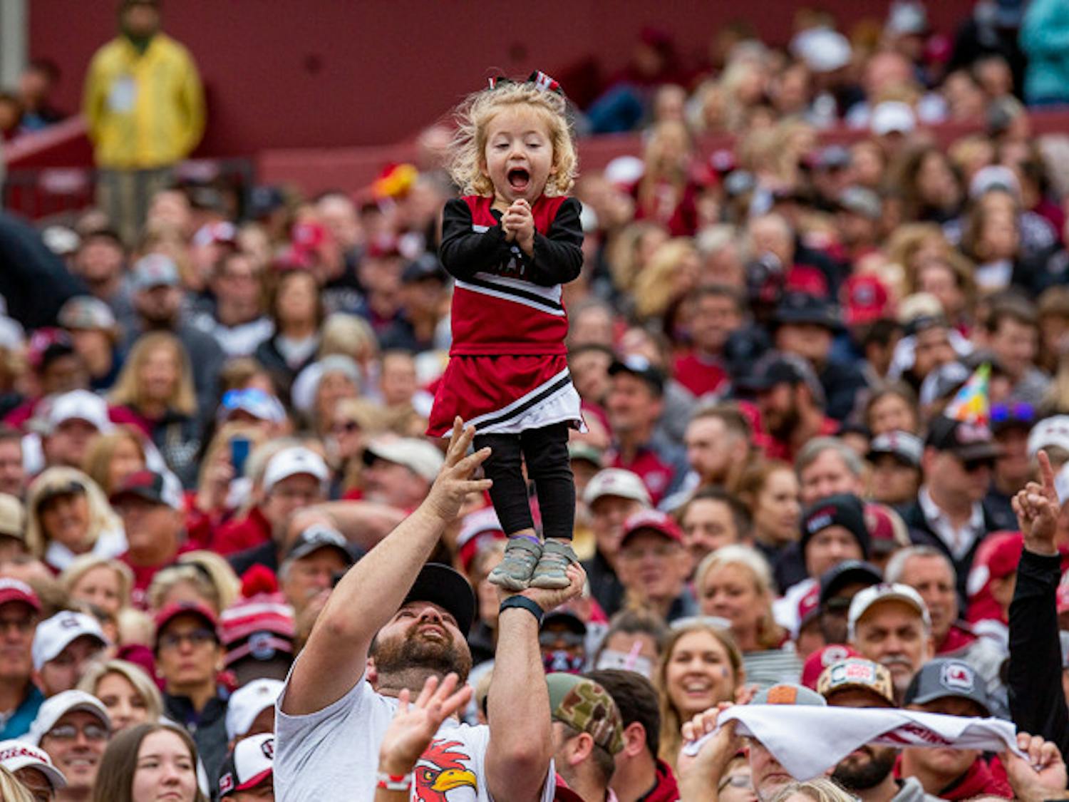 A child laughs with joy as her dad lifts her up at the South Carolina vs Missouri game on Oct. 29, 2022. The Tigers beat the Gamecocks 23-10.&nbsp;