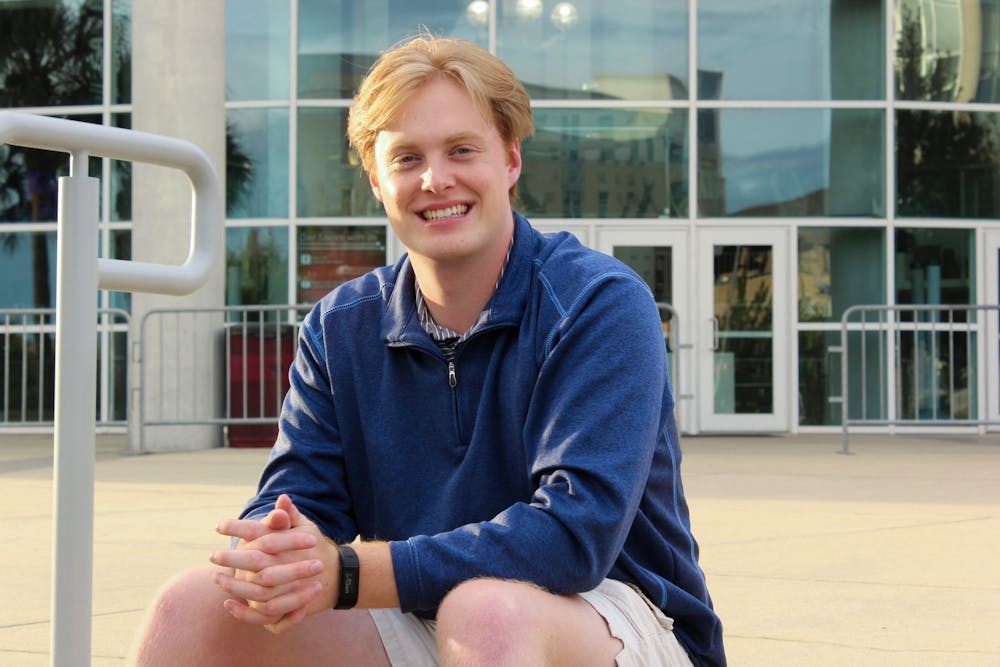 Michael Sauls, one of The Daily Gamecock’s managing editors, poses for a photo in front of Colonial Life Arena in Columbia, SC. Sauls has spent seven semester with The Daily Gamecock and is graduating from USC in December.