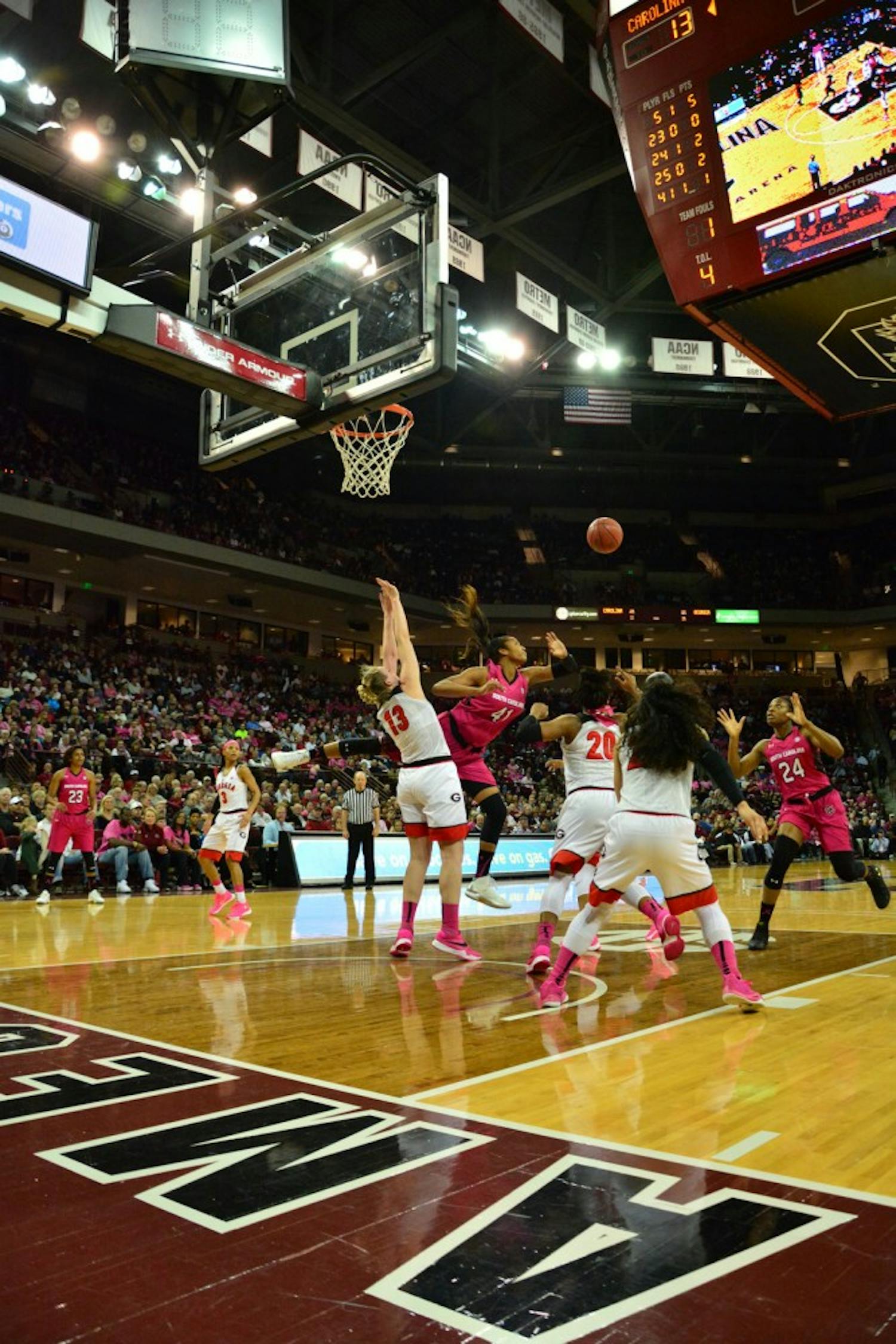 Sarah Imovbioh's (24) poor pass almost gets the Georgia Bulldogs' hands on the ball, but Alaina Coates (41) is determined to keep that from happening. South Carolina Gamecocks vs Georgia Bulldogs. Colonial Life Arena, Columbia, SC. February 18, 2016