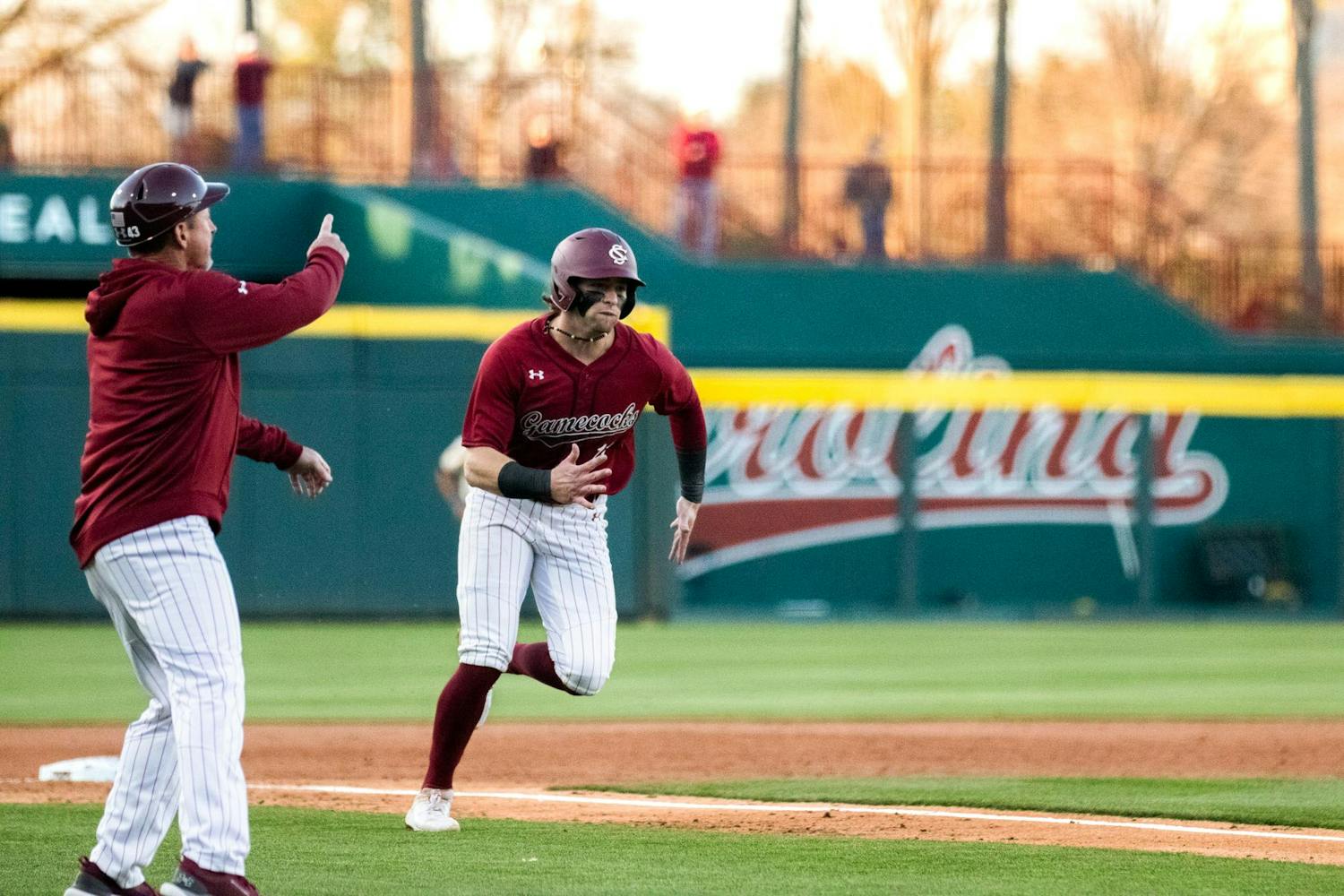 Fifth-year infielder Parker Noland runs to home base and scores against Queens on Feb. 21, 2024. Noland had two runs for the Gamecocks during its 13-3 victory over the Lions at Founders Park.