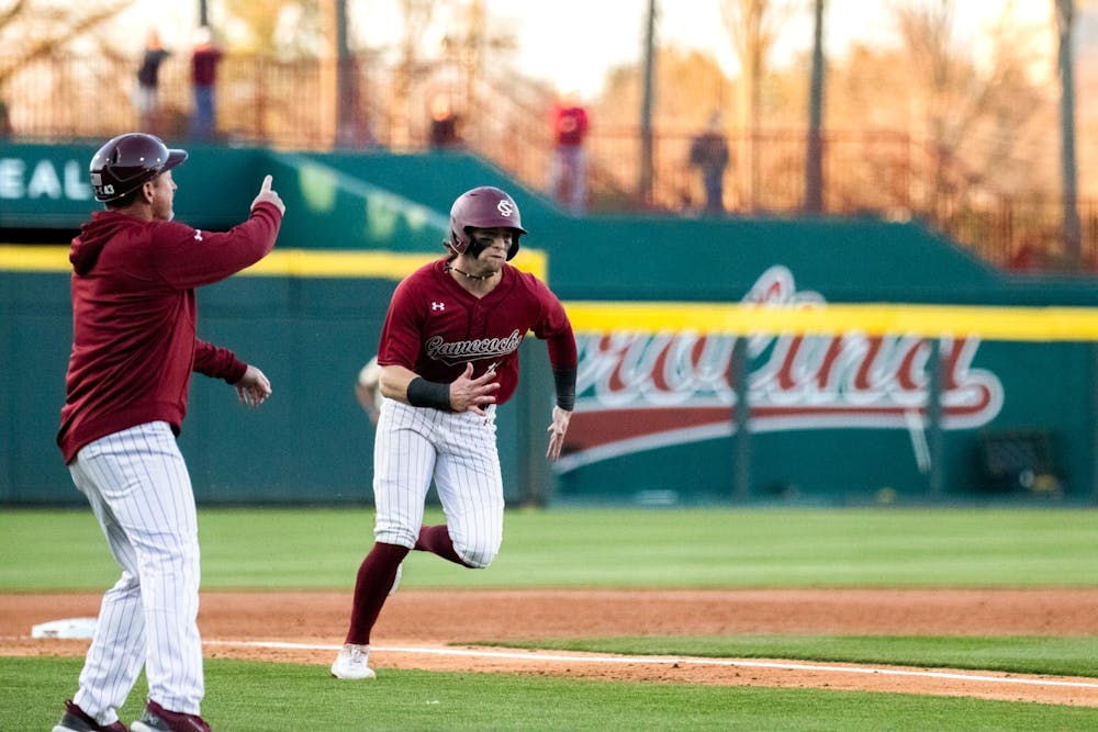 <p>Fifth-year infielder Parker Noland runs to home base and scores against Queens on Feb. 21, 2024. Noland had two runs for the Gamecocks during its 13-3 victory over the Lions at Founders Park.</p>