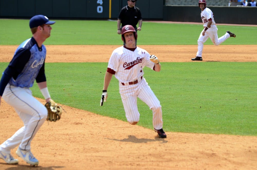 Tanner English races towards third base.