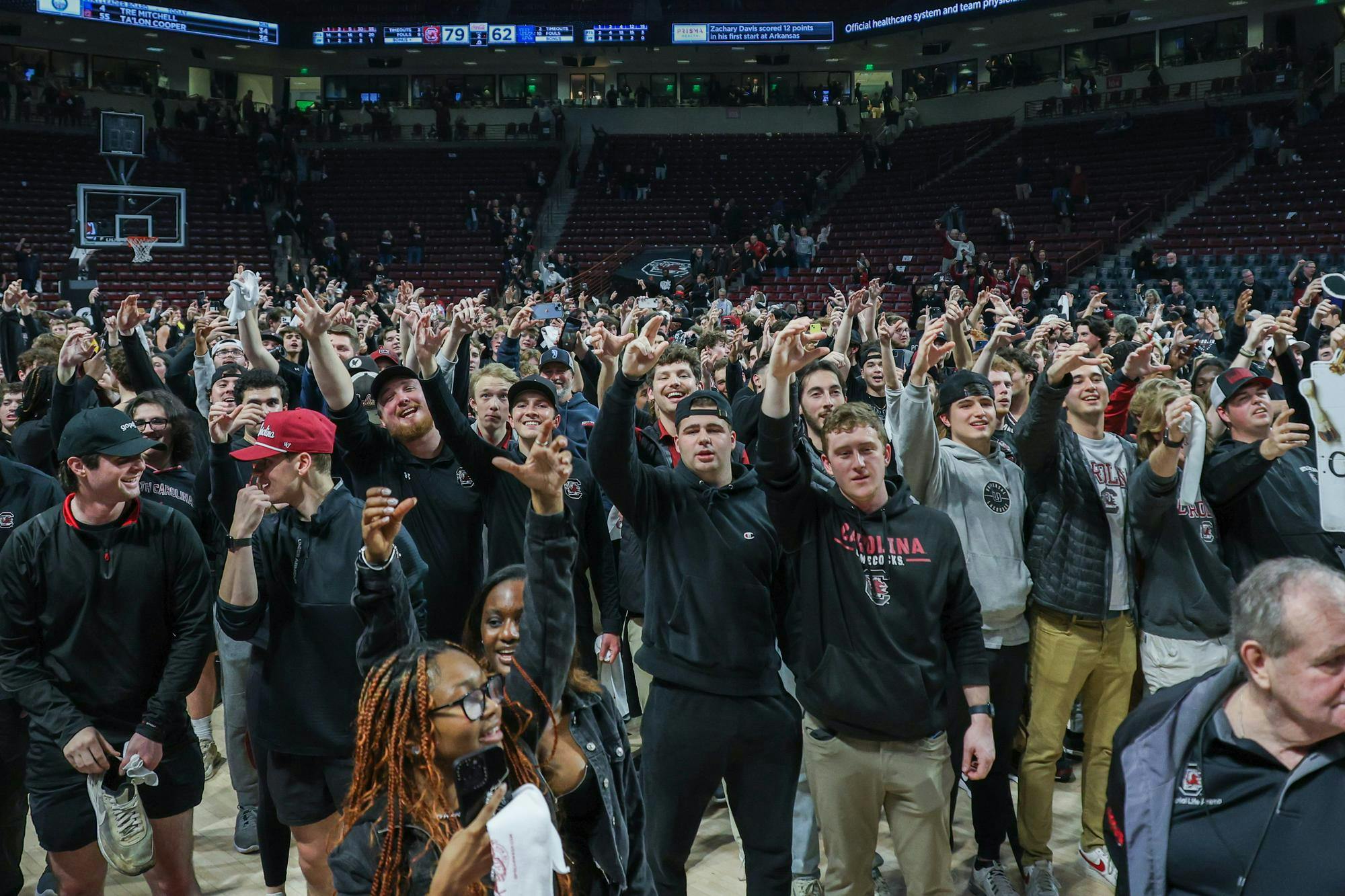 FILE- Gamecock fans raise their arms as a toast to South Carolina while the Carolina Band plays the alma mater following the men's basketball victory over Kentucky on Jan. 23, 2024. The Gamecock men's and women's basketball teams are participating in the NCAA Tournament this year as the No. 6 and No. 1 seeds, respectively.
