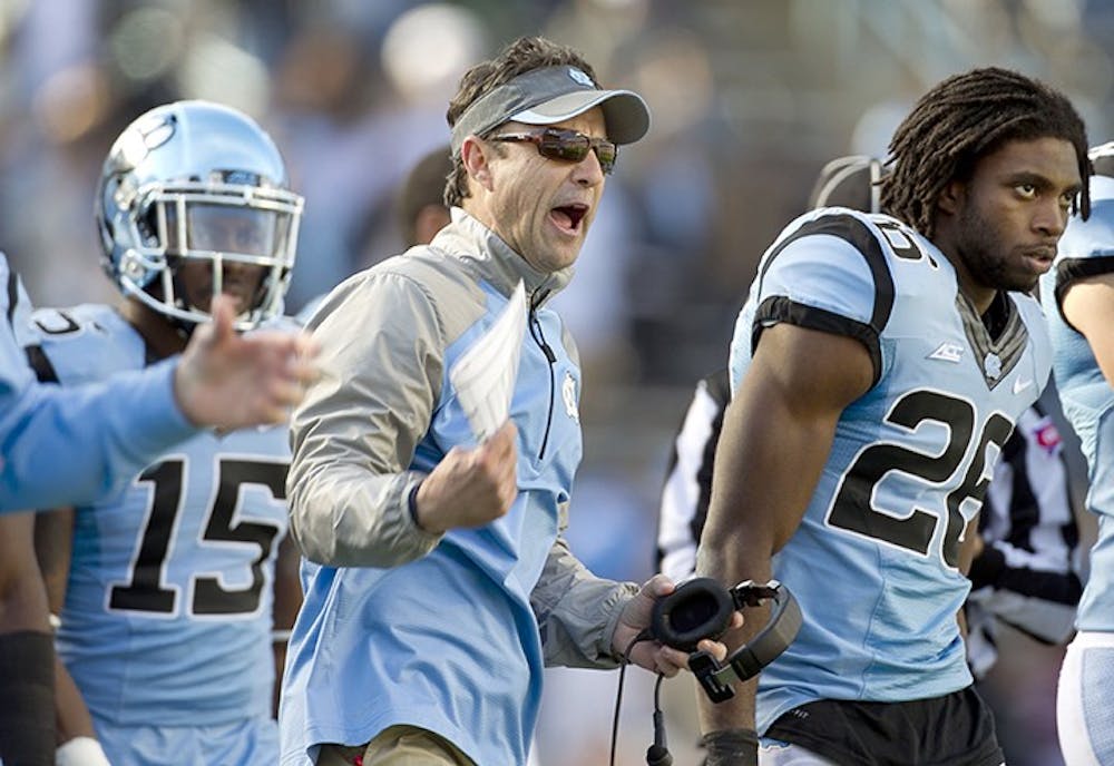 UNC head coach Larry Fedora reacts after N.C. State&apos;s Juston Burris (10) intercepted a Marquise Williams pass late in the second quarter on Saturday, Nov. 29, 2014 at Kenan Stadium in Chapel Hill, N.C. N.C. State won 25-7. (Robert Willett/Raleigh News &amp; Observer/TNS) 