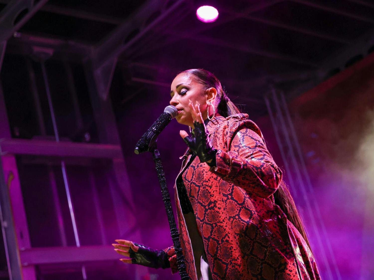 American singer-songwriter Mýa sings into a microphone while performing on the Smirnoff Main Stage at the Famously Hot SC Pride Festival on Oct. 4, 2025. Mýa was the final act of the night and performed many of her popular songs.