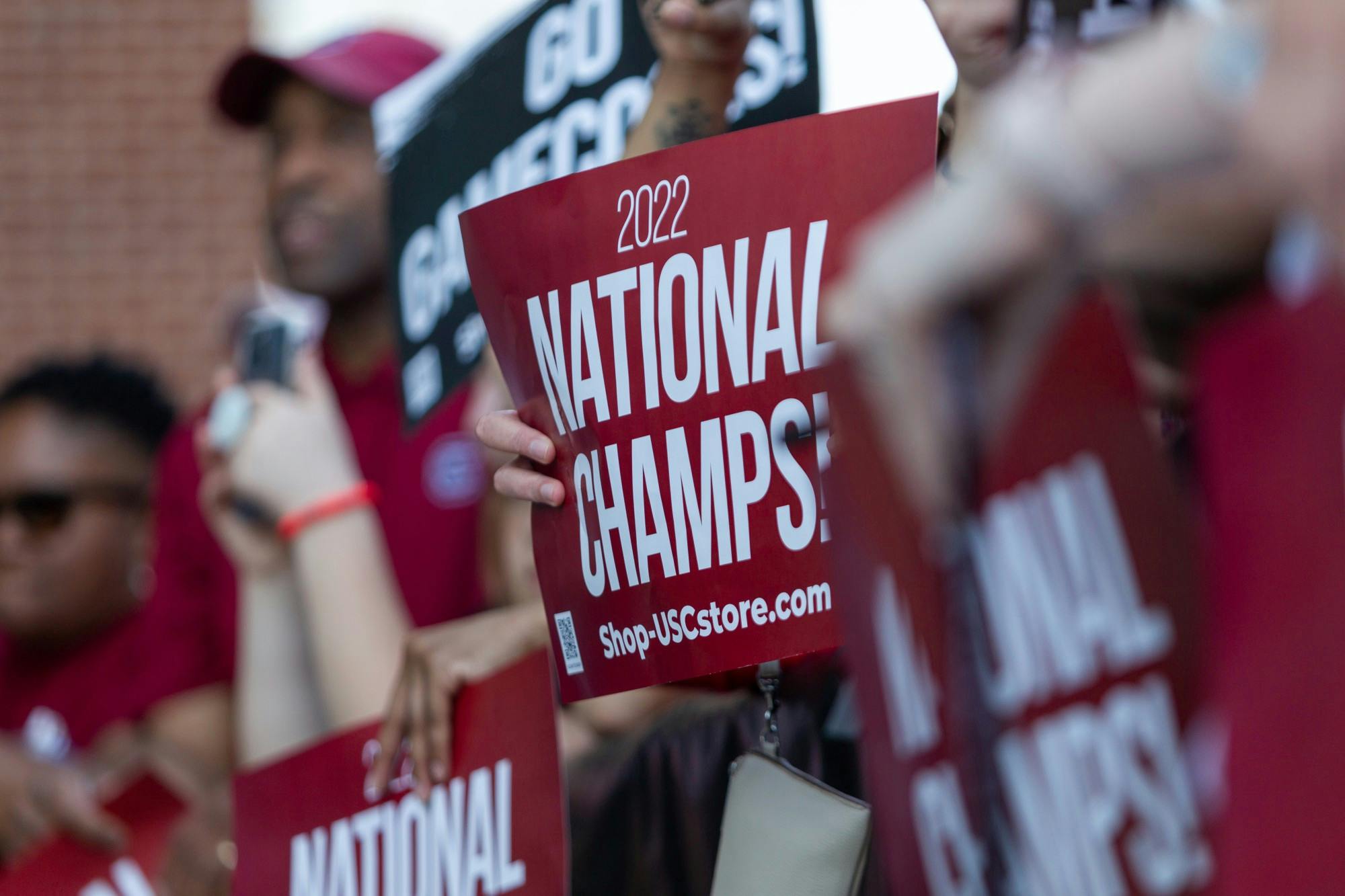 South Carolina fans hold signs at Colonial Life Arena in Columbia, SC on April 4, 2022. The outside of the arena was crowded with fans supporting the women's basketball team.