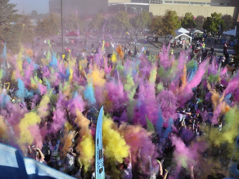 Runners in Saturday’s Color Me Rad 5K race run through downtown Columbia and pass through clouds of dyed corn starch on their way to and from Colonial Life Arena.