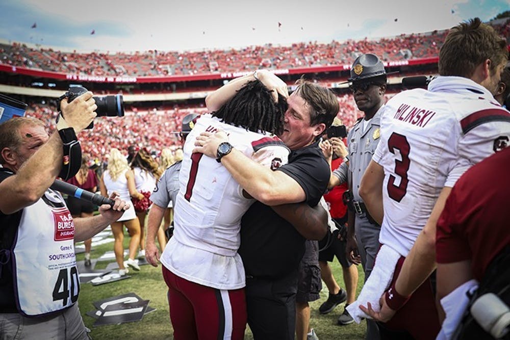 FILE—Former members of the South Carolina football team gather with former head coach Will Muschamp following a victory over Georgia on Oct. 12, 2019 in Athens, GA. This was the first time the Gamecocks beat the Bulldogs since 2014. 