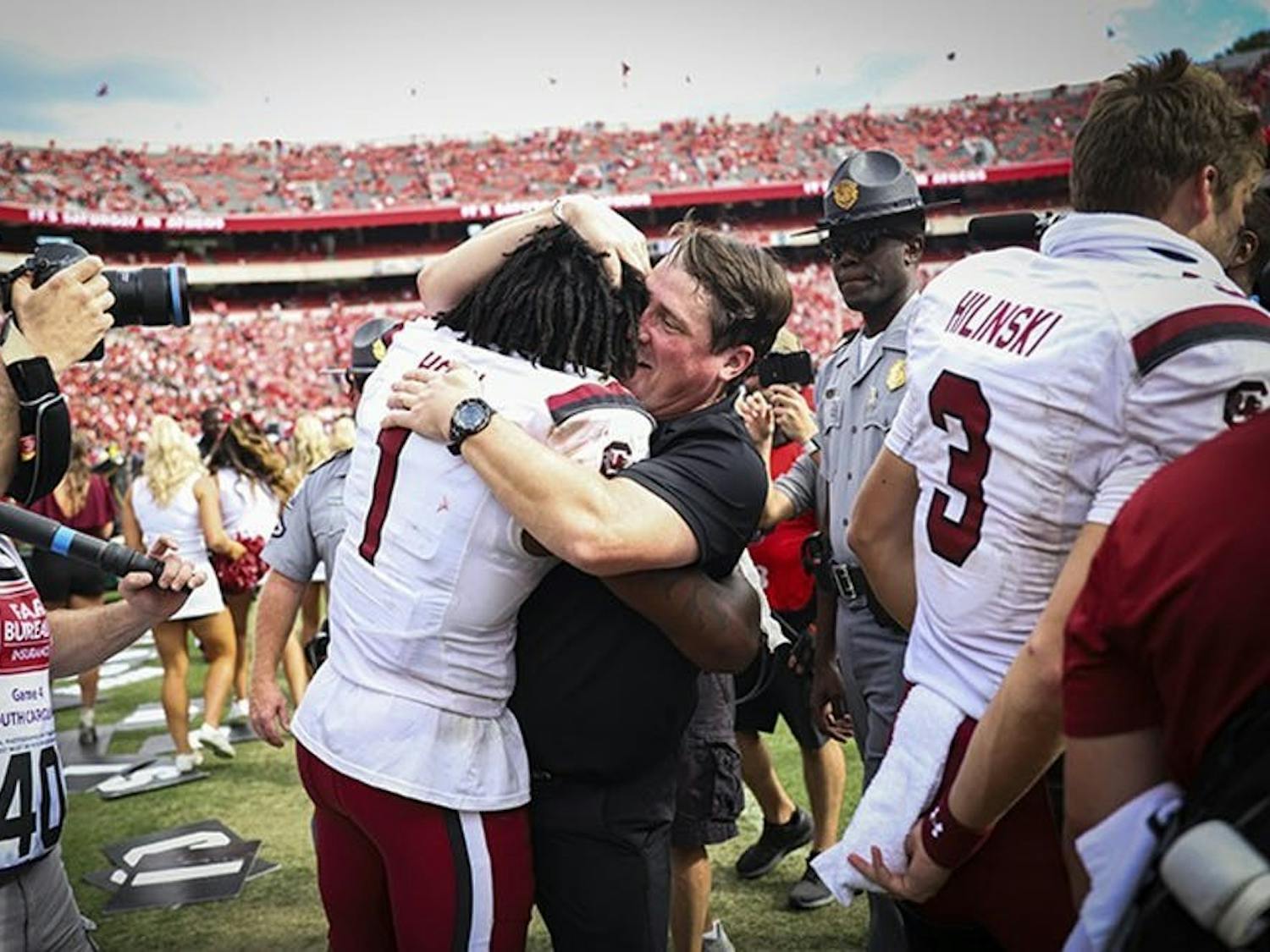 FILE—Former members of the South Carolina football team gather with former head coach Will Muschamp following a victory over Georgia on Oct. 12, 2019 in Athens, GA. This was the first time the Gamecocks beat the Bulldogs since 2014. 