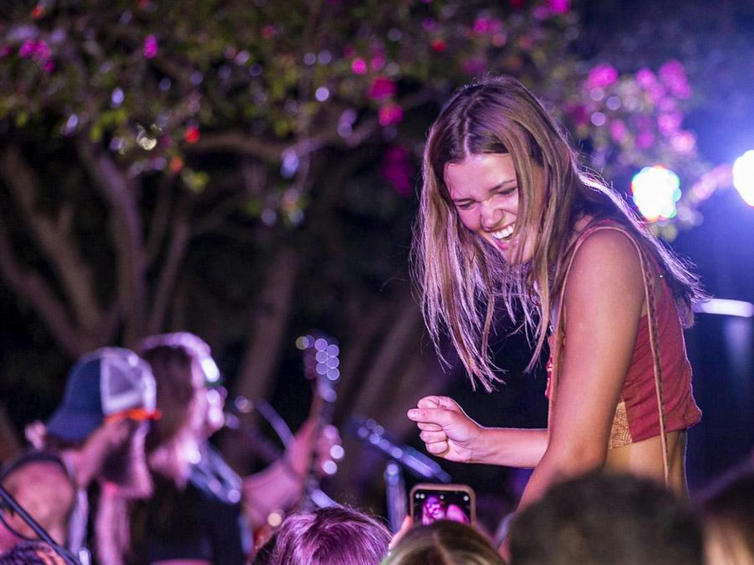 A South Carolina student sits atop her friend's shoulders during a concert at the First Night Carolina event on Aug. 23, 2023. The event featured musical performances from The L.A. Maybe and DJ iAM.