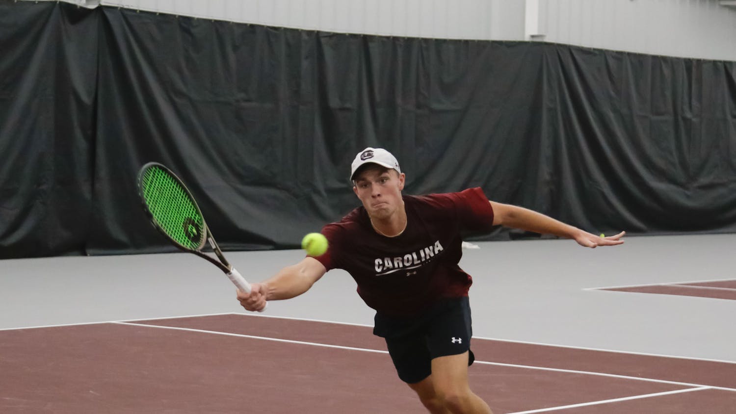 Junior James Story reaches for the ball during his doubles match at the ITA Kickoff Weekend event at the Carolina Indoor Tennis Center on Jan. 28, 2023. South Carolina beat Penn 4-0.