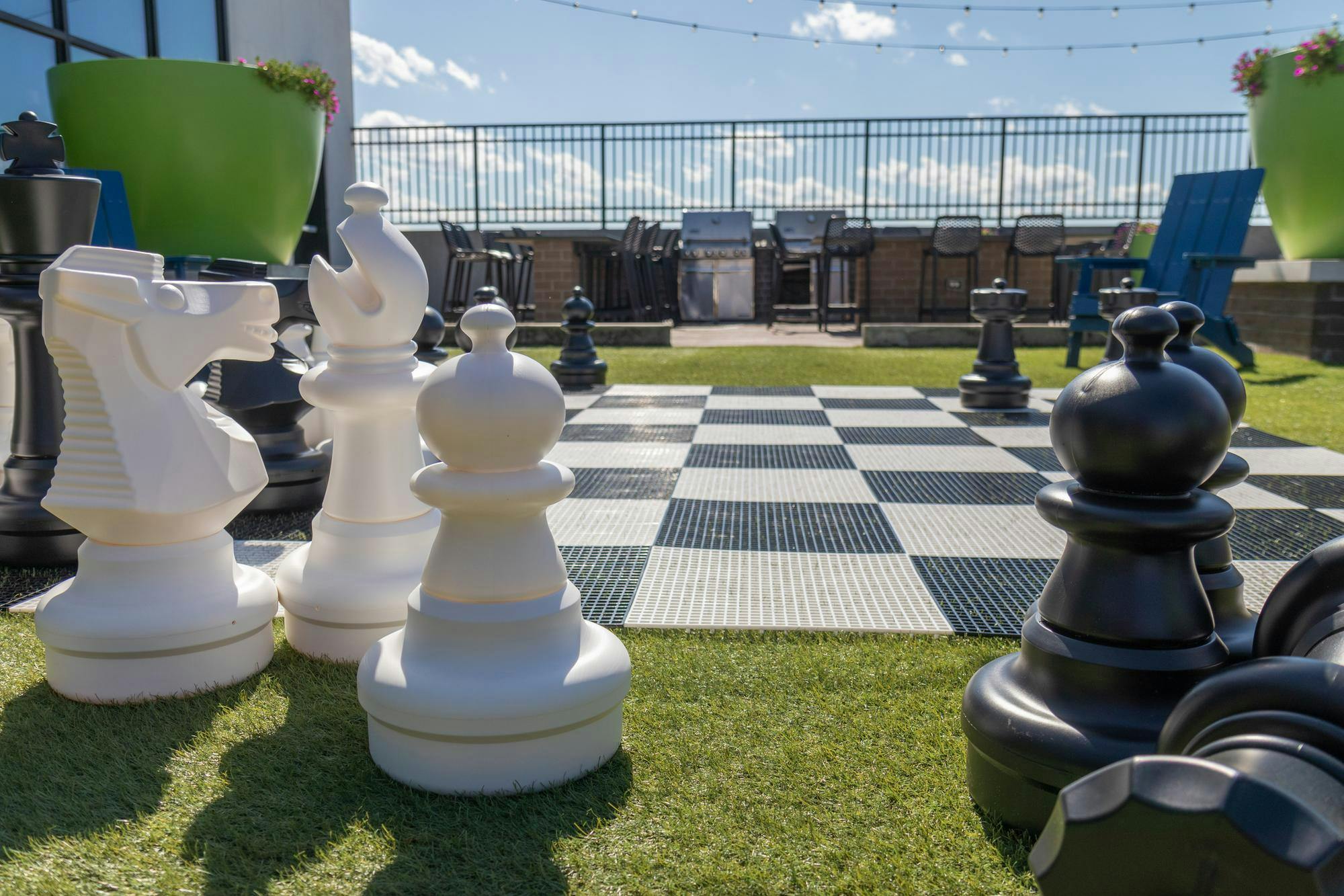 Large-scale chess pieces sit on the lawn on the roof of Empire Columbia on Apr. 4, 2024. The top floor of the apartment complex includes a gym, golf simulator, and a large screen overlooking the pool for watching live sporting events and movies.