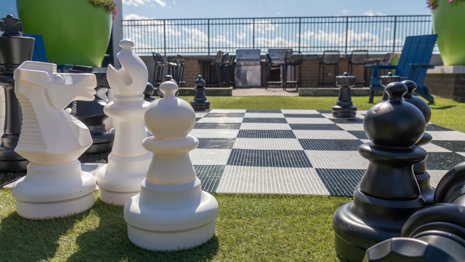 Large-scale chess pieces sit on the lawn on the roof of Empire Columbia on Apr. 4, 2024. The top floor of the apartment complex includes a gym, golf simulator, and a large screen overlooking the pool for watching live sporting events and movies.