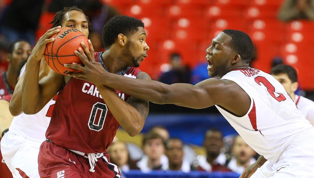 South Carolina&apos;s Sindarius Thonwell (0) works against Arkansas&apos; Alandise Harris during the second half in the second round of the SEC Tournament on Thursday, March 13, 2014, at the Georgia Dome in Atlanta. South Carolina advanced, 71-69. (Curtis Compton/Atlanta Journal-Constitution/MCT)