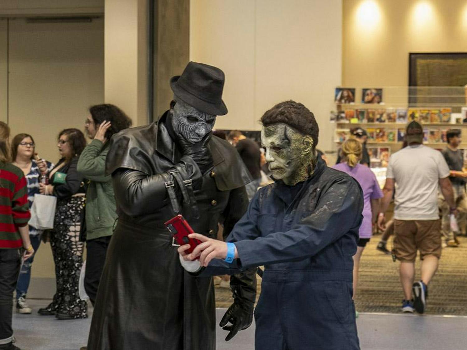Cole Bapties (right), from Beaufort, South Carolina, and dressed as Michael Myers from the "Halloween" horror franchise, takes a selfie with a cosplayer wearing a "Resident Evil" Mr. X costume (left) at the South Carolina Horror Convention on Sept. 16, 2023. The convention featured a cosplay competition on Sept. 17, 2023, where attendees dressed up as their favorite horror characters.