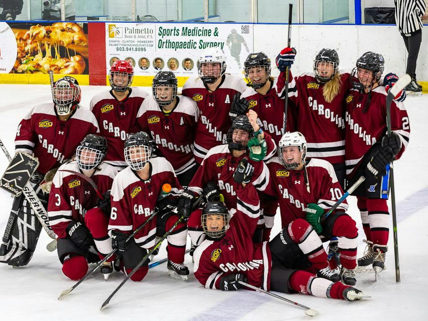 The Carolina women's club hockey team celebrates after its 2-1 victory against the South Carolina Lady Warriors on Oct. 1, 2023 in Irmo, S.C. This matchup marks the first recorded female hockey game in the 222-year history of USC.