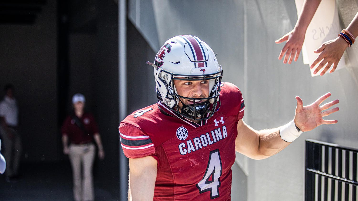 FILE — Redshirt senior quarterback Luke Doty high-fives fans while running out of the tunnel before the Troy football game on Saturday, Oct. 2, 2021. Doty has been playing as a wide receiver for the Gamecocks in the 2023 season, changing his impact on the team.