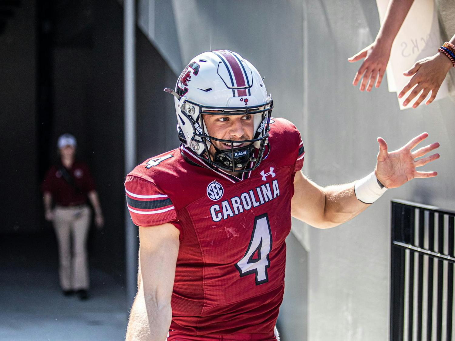 FILE — Redshirt senior quarterback Luke Doty high-fives fans while running out of the tunnel before the Troy football game on Saturday, Oct. 2, 2021. Doty has been playing as a wide receiver for the Gamecocks in the 2023 season, changing his impact on the team.