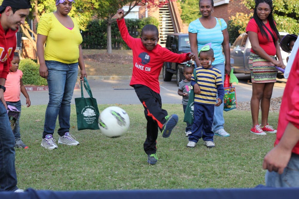 Jeremy Green attempts to make a soccer goal to win candy at one of the booths.