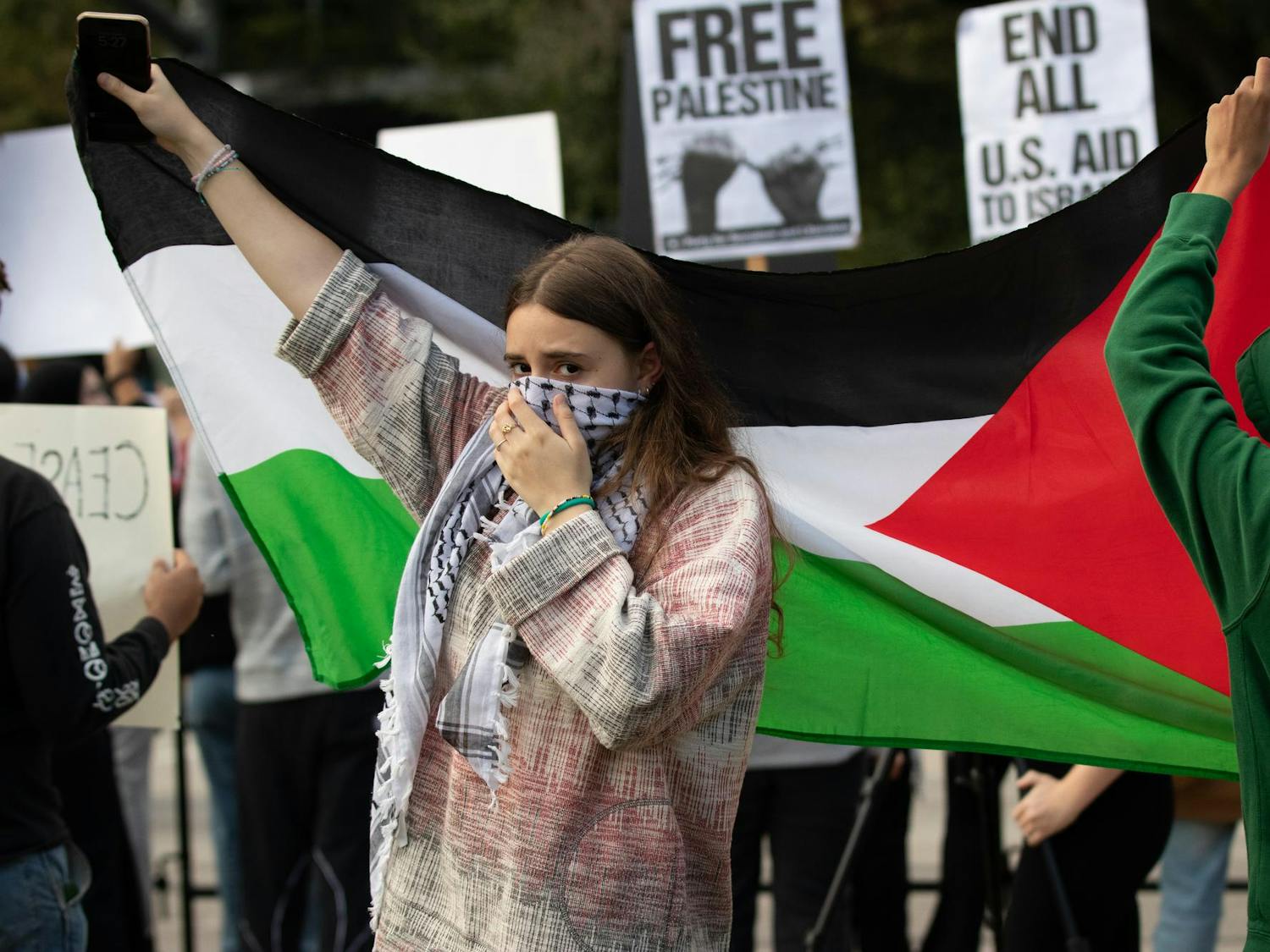 A rally attendee holds up a Palestinian flag prior to the Free Palestine Emergency Demonstration. The rally was held by the North and South Carolina Party for Social Liberation at the South Carolina Statehouse on Oct. 27, 2023.