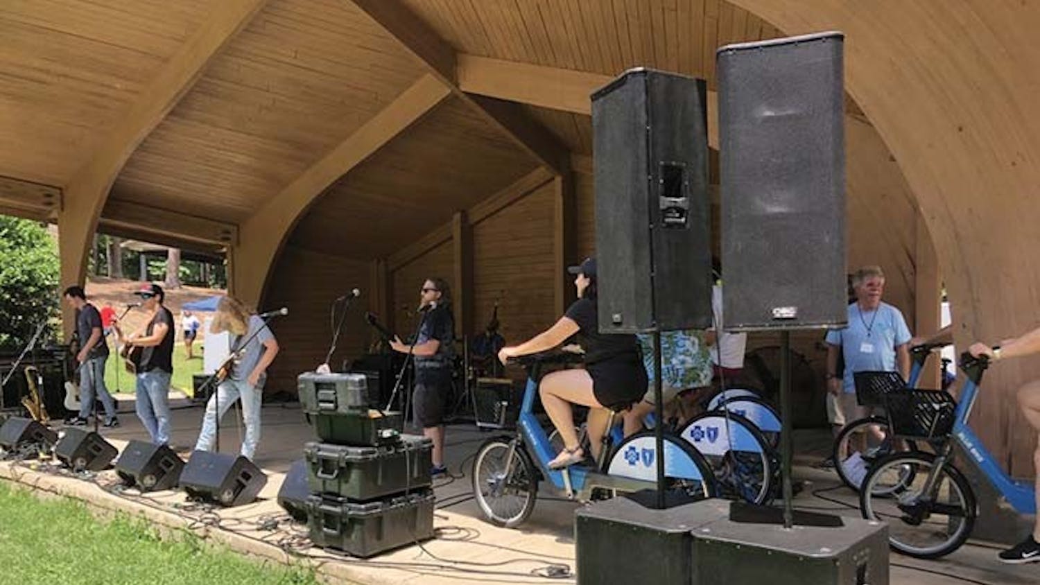 Volunteers ride stationary bikes powering live music at SolFest RollFest on July 2, 2022. This is the first bike-powered music festival in Columbia. 