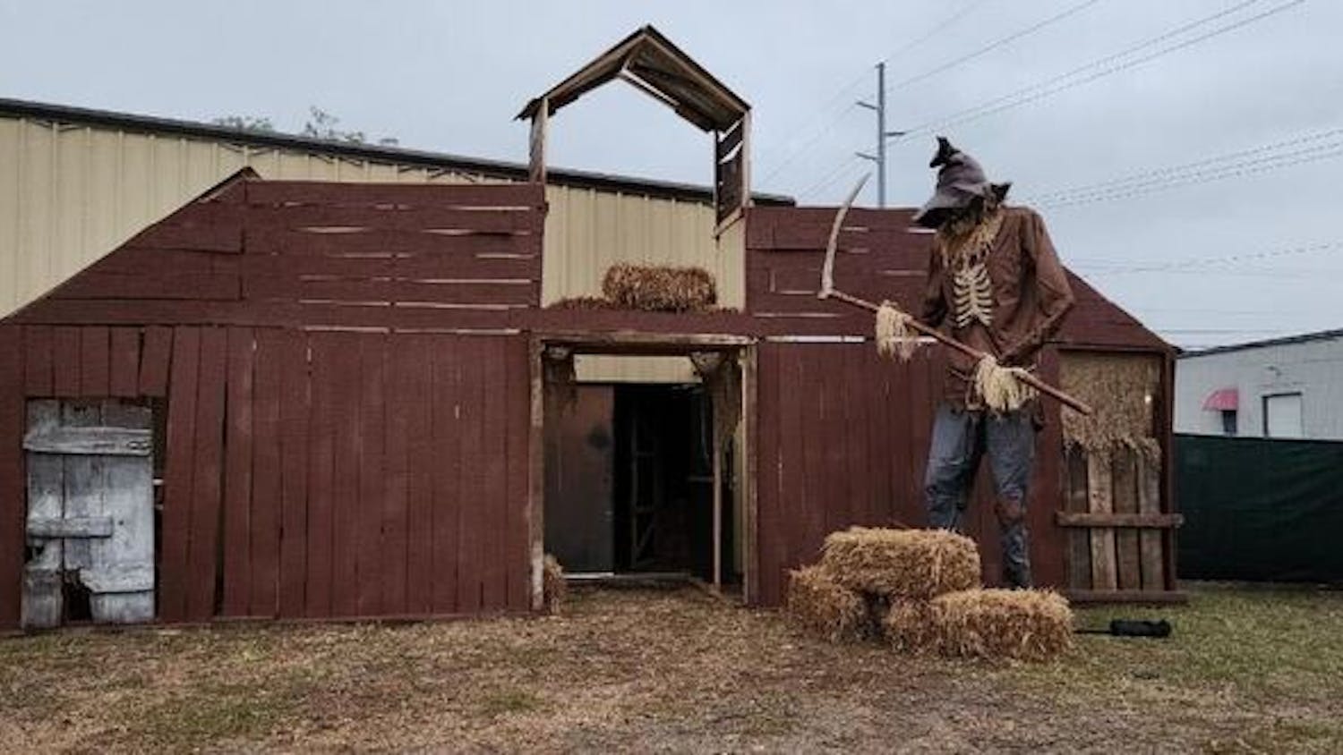 A large, scythe-wielding scarecrow towers over the entrance of the Hall of Horrors attraction in Cayce, South Carolina, throughout October 2023. A portion of the proceeds raised at the attraction goes to Camp Hope, a summer camp for people with cognitive disabilities.