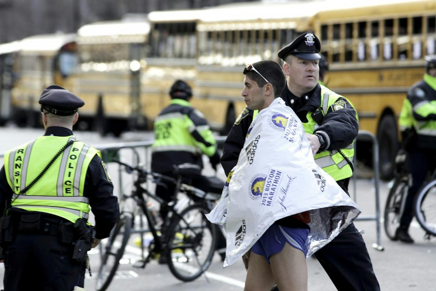 Police help a runner after multiple explosions rocked the finish line of the Boston Marathon on Monday, April 15, 2013, in Boston, Massachusetts. (Nicolaus Czarnecki/Zuma Press/MCT)